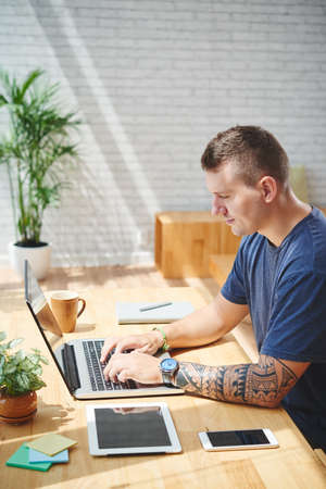 Coding man doing work in cafeの写真素材