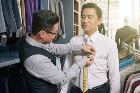 Tailor taking measuresの写真素材