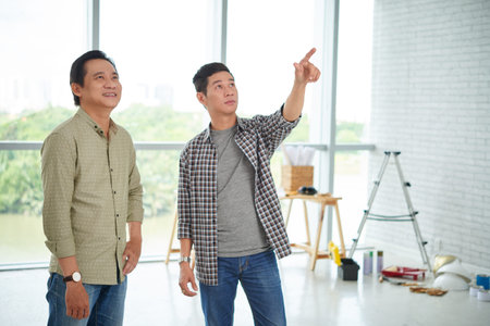 Vietnamese business people discussing repairs of new officeの写真素材