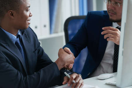 Coworkers shaking handsの写真素材