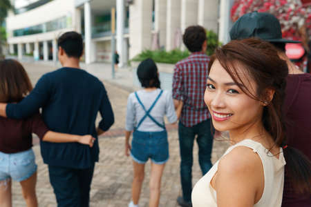 Attractive Vietnamese woman walking in the street with her boyfriendの写真素材