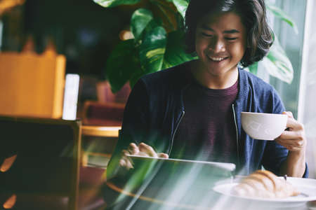Young man in cafeの写真素材