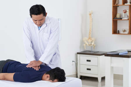 Chiropractor adjusting spineの写真素材