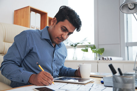 Professsional engineer drinking coffee when working on construction project