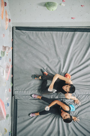 Climbers resting on mat