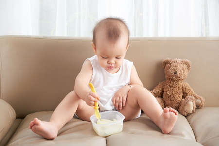 Little girl eating pearの写真素材