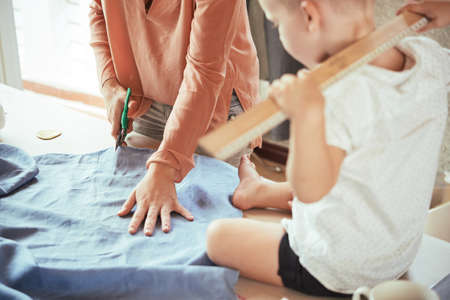 Mother working in sewing workshopの写真素材