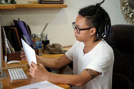 Tattoo master looking at paper sheet with new sketch
