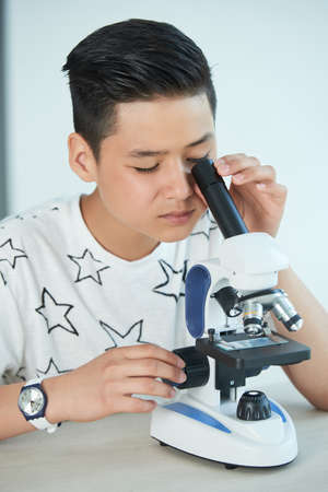 Teen with microscopeの写真素材
