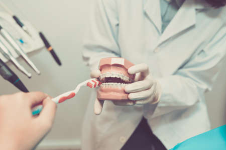 Brushing teeth with bracesの写真素材