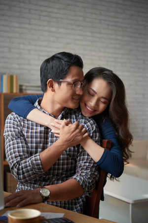 Young woman hugging her boyfriend