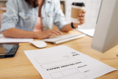 Close-up of empty blank lying on the table at post office with female worker sitting in the backgroundの写真素材