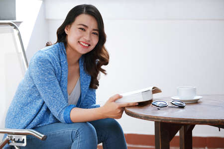 Woman reading in cafeの写真素材