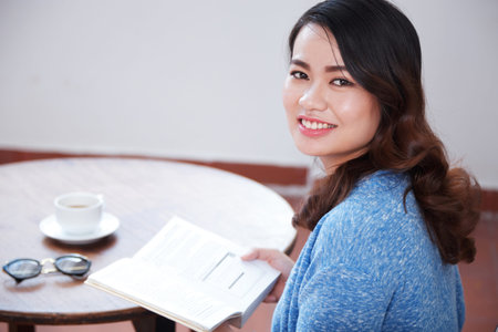 Woman enjoying coffee and book