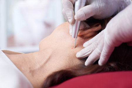 Close-up of female face with doctor in protective gloves doing cosmetology procedure