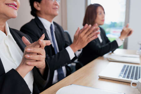 Cropped image of business people clapping to support speaker at presentationの写真素材