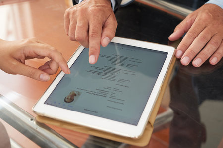 Business people watching resume online on tablet pc at the table