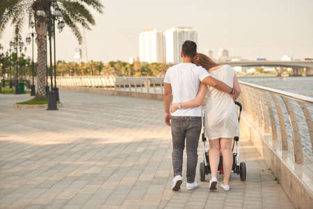 Young family walkin with strollerの写真素材