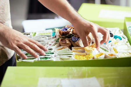 Close-up of male tailor choosing yellow  in the box for his workの写真素材