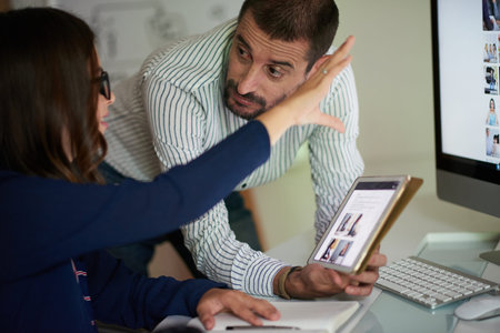 Colleagues discussing interfaceの写真素材