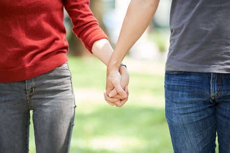 Cropped image of couple holding hands when walking outdoors together