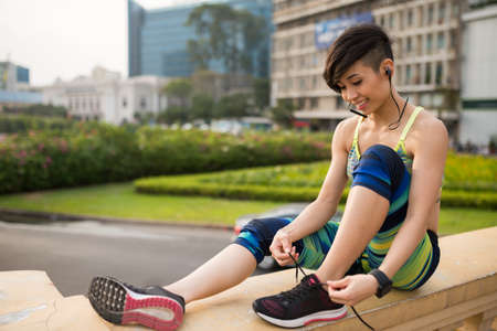 Sportswoman tying shoelacesの写真素材