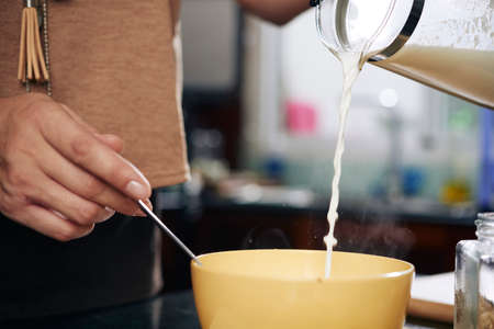 Adding some milkの写真素材