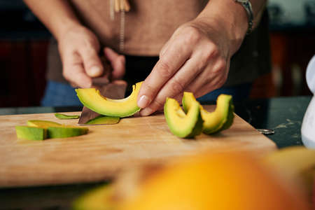 Peeling cut avocadoの写真素材