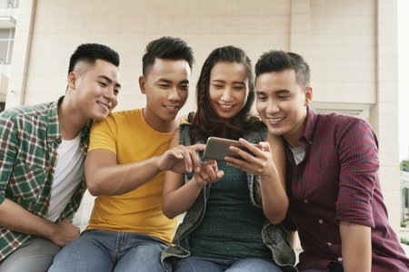 Friends watching funny videosの写真素材