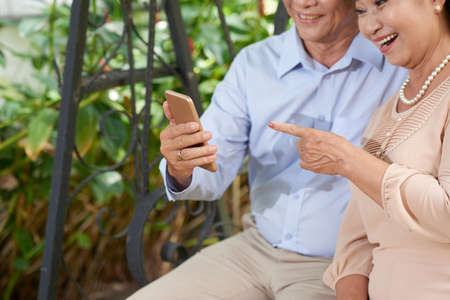 Happy couple with smartphoneの写真素材