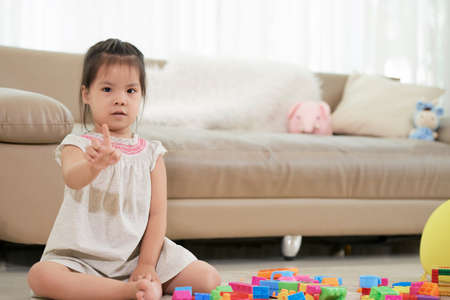 Girl showing one fingerの写真素材