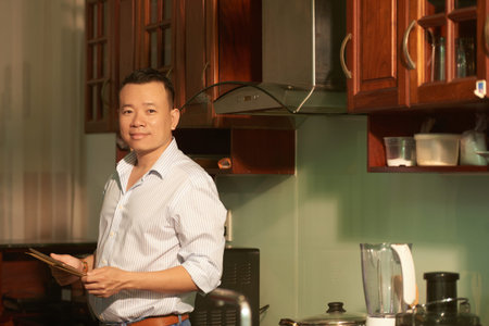Happy man in his kitchen