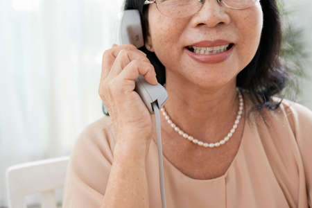 Smiling woman talking on phoneの写真素材