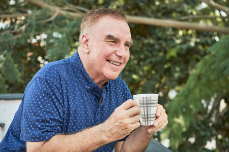Man drinking coffee outdoors