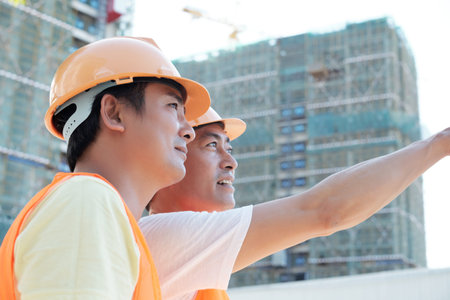 Construction workers discussing work
