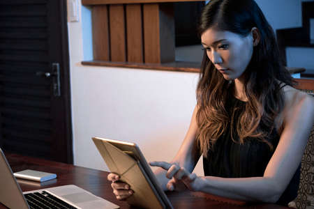 Woman working on tablet computerの写真素材