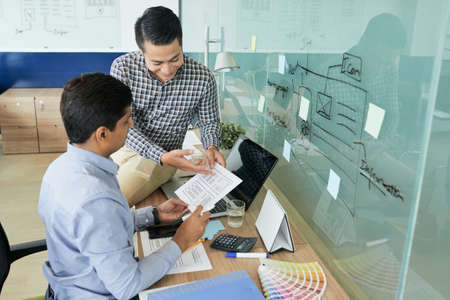 Designers discussing webpage templateの写真素材