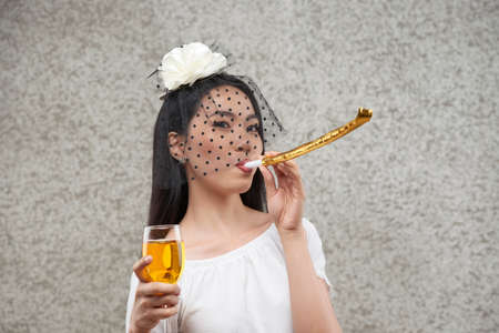 Party guest blowing in whistleの写真素材