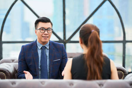 Businessman talking to female colleagueの写真素材