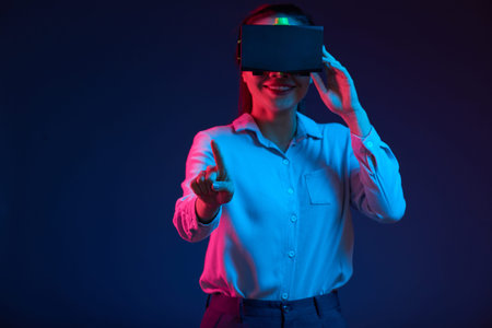 Businesswoman in VR headset pushing button