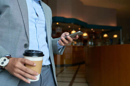 Entreprneur drinking coffee and textingの写真素材