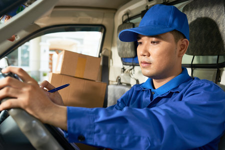 Delivery man checking addresses