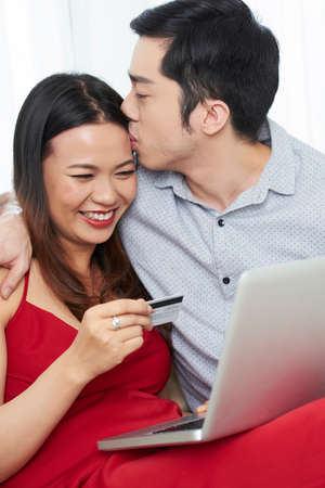 Couple in love online shopping togetherの写真素材