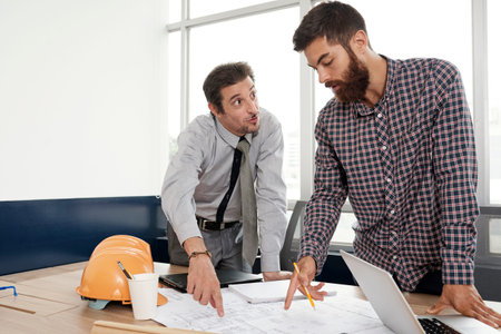 Engineers arguing about blueprint