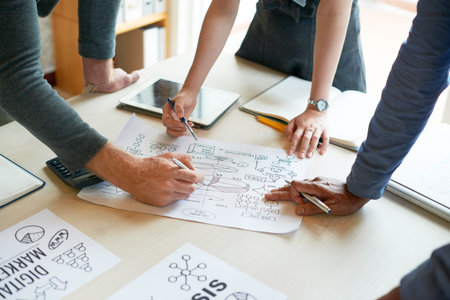 Business people discussing chart on office table