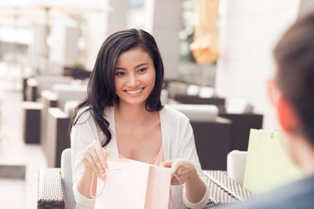 Pretty woman opening paper-bagの写真素材