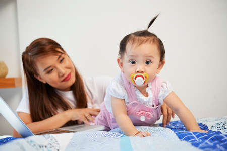 Crawling baby with pacifierの写真素材