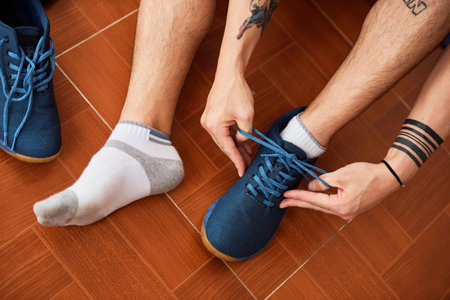 Man tying shoe laces