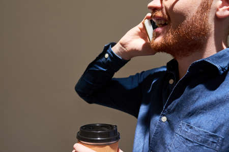 Man calling and drinking coffeeの写真素材
