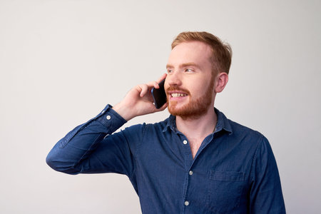 Cheerful man calling on phone